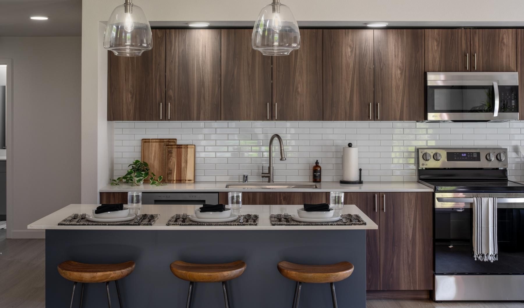 a kitchen with an island and stools