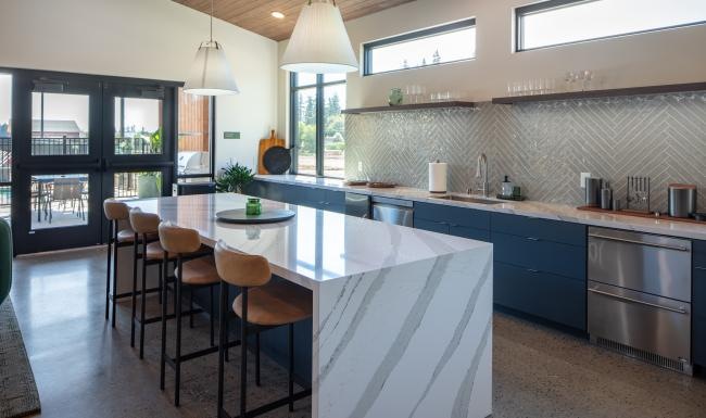 a kitchen with a bar and chairs