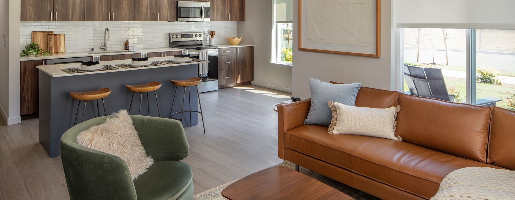 a living room with a couch, chairs and a table