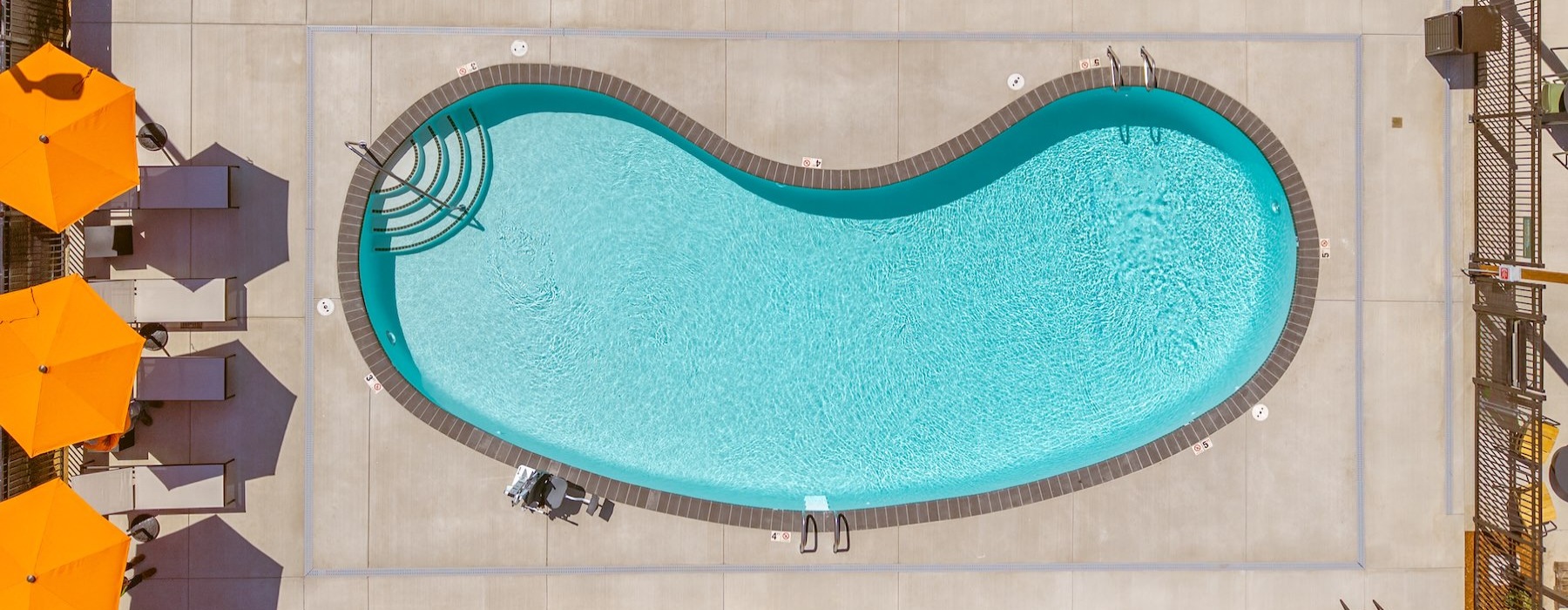 a pool with orange umbrellas