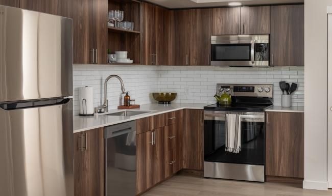a kitchen with wooden cabinets