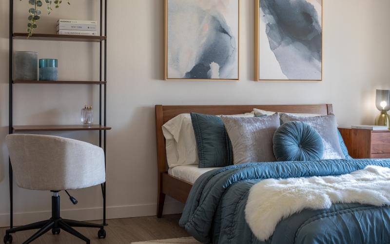 a bedroom with a bed and a chair